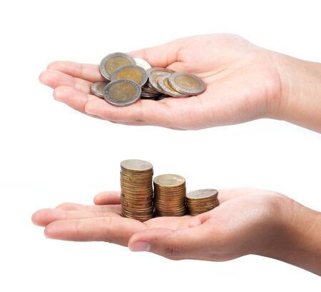 picture of two hands full of coins over white backgroundの写真素材