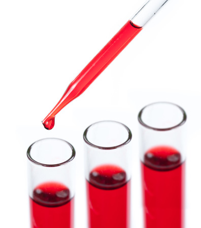 liquid dripping from pipette into test tube isolatedの写真素材