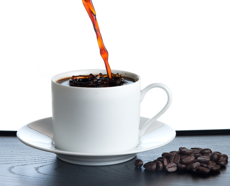 splash coffee isolated on white backgroundの写真素材
