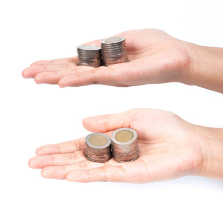 picture of two hands full of coins over white backgroundの写真素材