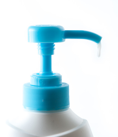 Bottle of blue liquid soap with drops of water isolated on white backgroundの写真素材