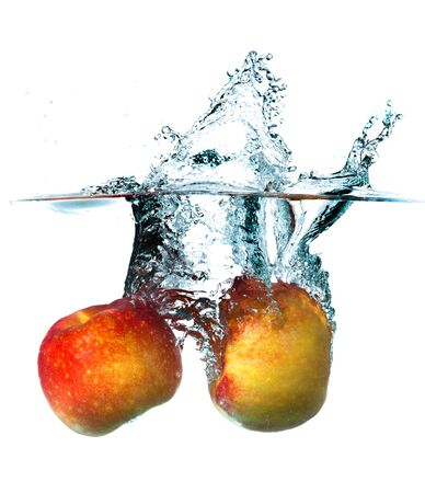 Apple dropping into waterの写真素材
