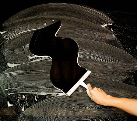 Hand carefully cleaning window.の写真素材