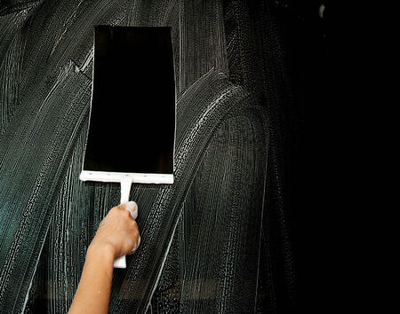 Hand carefully cleaning window.の写真素材