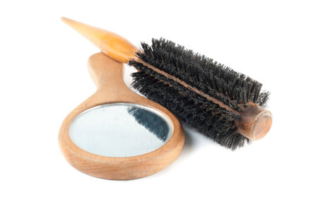 comb and looking glass over white