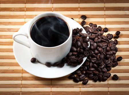 Coffee cup and saucer on a woodenの写真素材