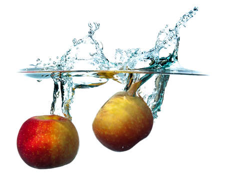 Apple dropping into waterの写真素材