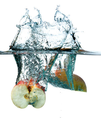Apple dropping into waterの写真素材