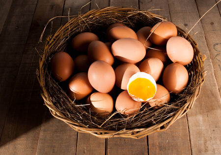 eggs in a nest on wood backgroundの写真素材