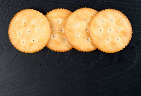 cracker on black  woodenの写真素材