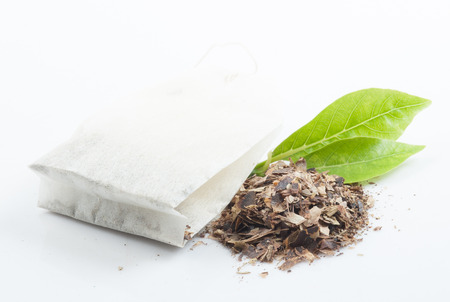 Tea bag with leaves isolated on white backgroundの写真素材