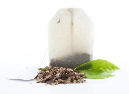 Tea bag with leaves isolated on white backgroundの写真素材