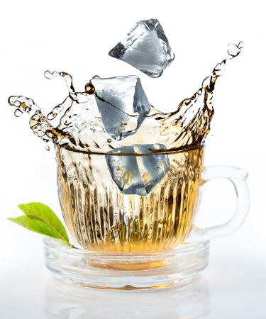 Ice tea with splash in glassの写真素材