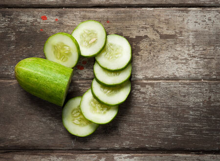 cucumber slices on wooden backgroundの写真素材
