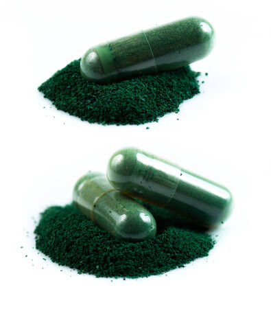 green herbal medicine capsule isolated on white backgroundの写真素材