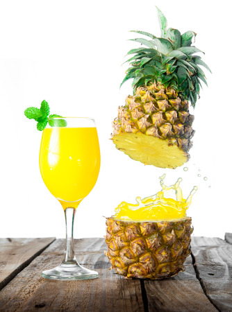 splash pineapple juice on woodの写真素材