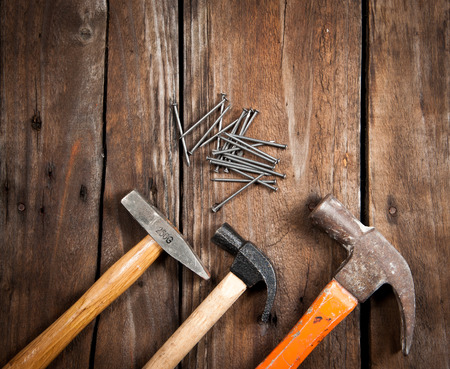 Hammer and nails on woodの写真素材