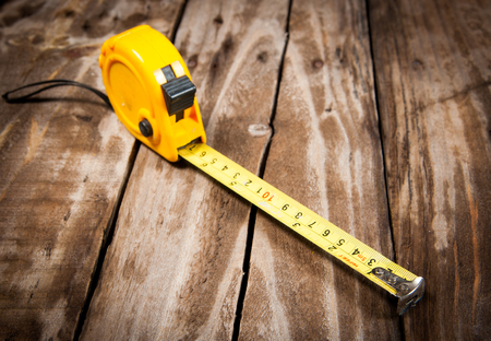 tape measure on the  wooden backgroundの写真素材