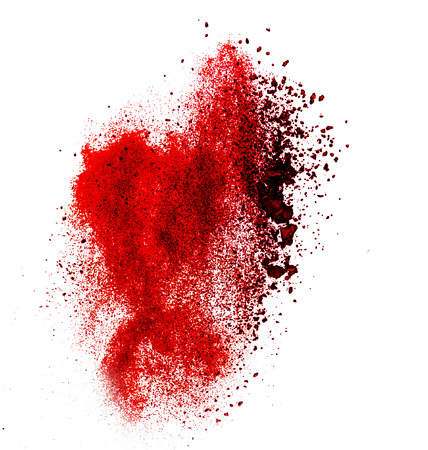 red powder explosion isolated on whiteの写真素材