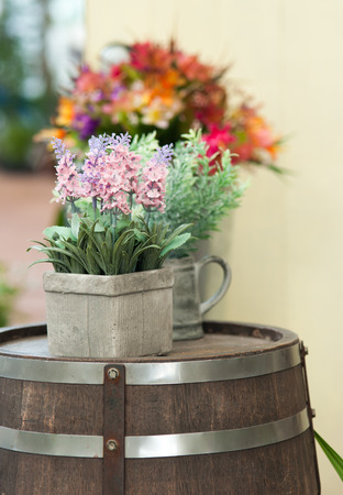 flowers on old wine tank in rock gardenの写真素材
