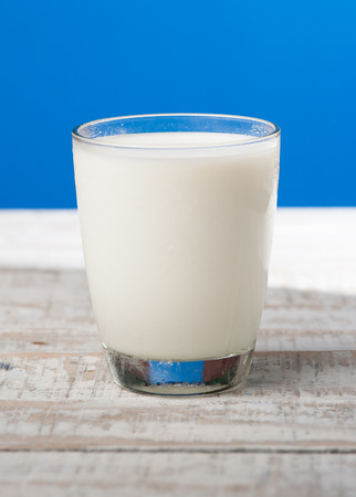 milk on wooden,blue backgroundの写真素材