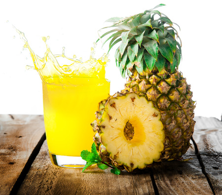 Pineapple with splash on woodの写真素材