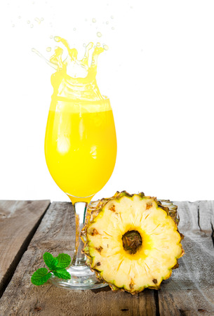Pineapple with splash on woodの写真素材