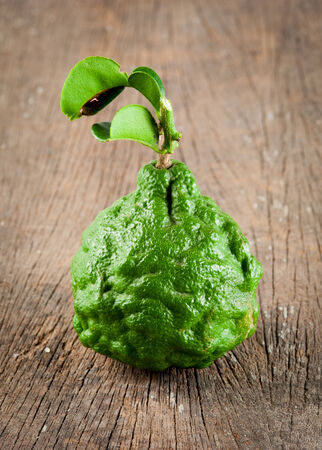 Bergamot fruit with leaf on woodの写真素材