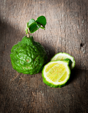 Bergamot fruit with leaf on woodの写真素材