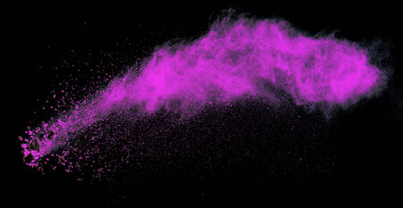 Launched colorful powder, isolated on black backgroundの写真素材