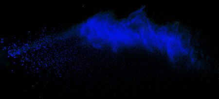 Launched colorful powder, isolated on black backgroundの写真素材