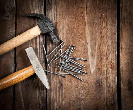 Hammer and nails on woodの写真素材