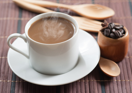 cup of coffee and Wooden Spoon on wood table, selective focusの写真素材