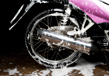 Washing the Pink motorcycleの写真素材