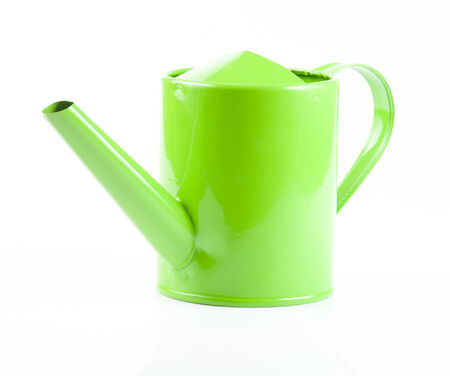 Green watering can in front of a white backgroundの写真素材