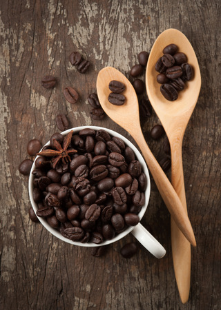 Coffee beans in cup on wood background,selective focusの写真素材