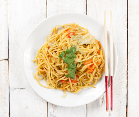 noodles and vegetables on woodの写真素材