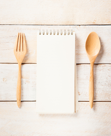 blank recipe book with wooden spoonの写真素材