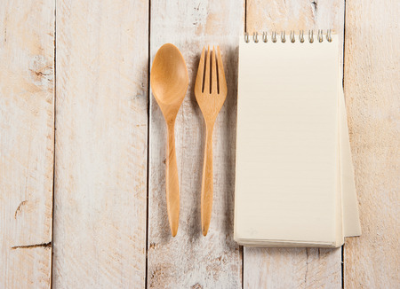 blank recipe book with wooden spoonの写真素材