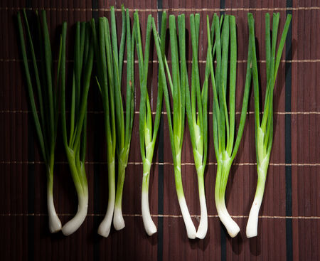 Chopped green onions on a woodenの写真素材