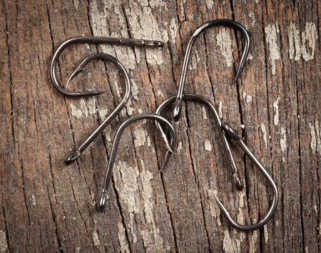 fish hook on wood backgroundの写真素材