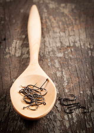 fish hook with spoon on wood background, selective focusの写真素材