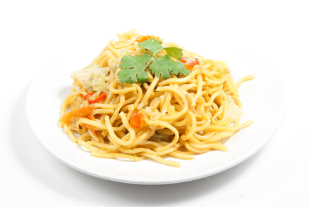 noodles and vegetables on white plateの写真素材