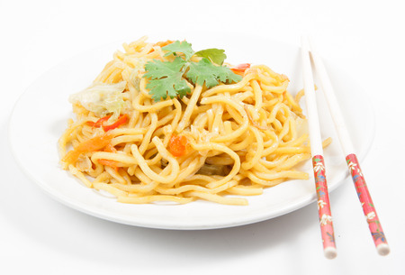 noodles and vegetables on white plateの写真素材
