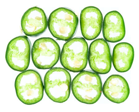Fresh Green pepper slices isolated on whiteの写真素材