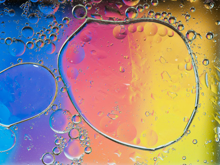 Background of colorful oil drops in waterの写真素材