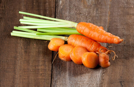 fresh carrots bunch on woodの写真素材