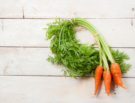 Fresh washed carrots on white wooden tableの写真素材