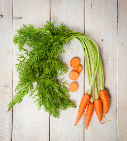 Fresh washed carrots on white wooden tableの写真素材
