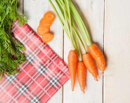Fresh washed carrots on white wooden tableの写真素材